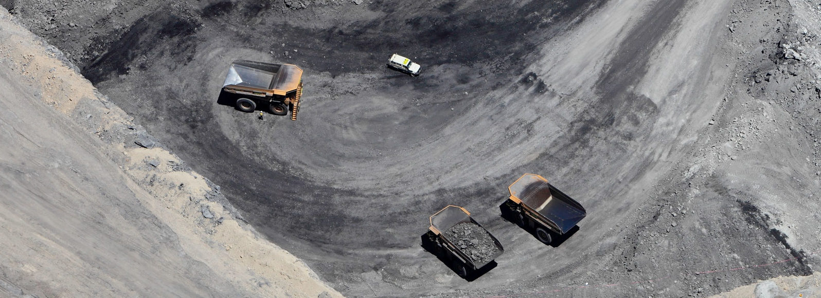 Ariel view image of Tarrawonga mine with orange trucks scattered around, filled with coal